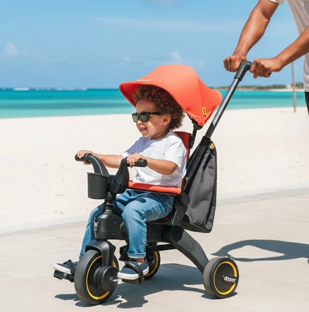 Toddler riding a Doona Liki Trike along an Aruba beach path