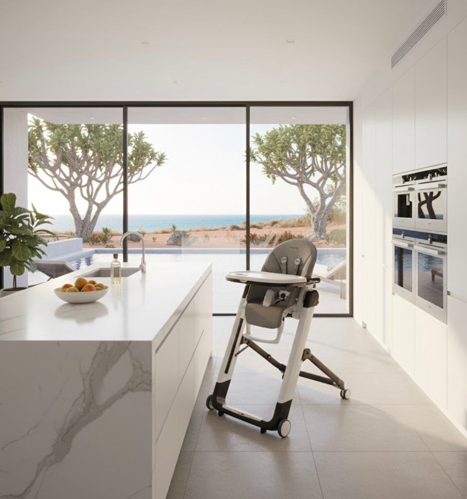 Peg Perego Siesta high chair in a bright kitchen with an ocean view